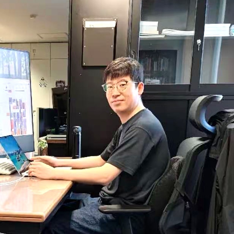 Guang Li at his desk in the lab